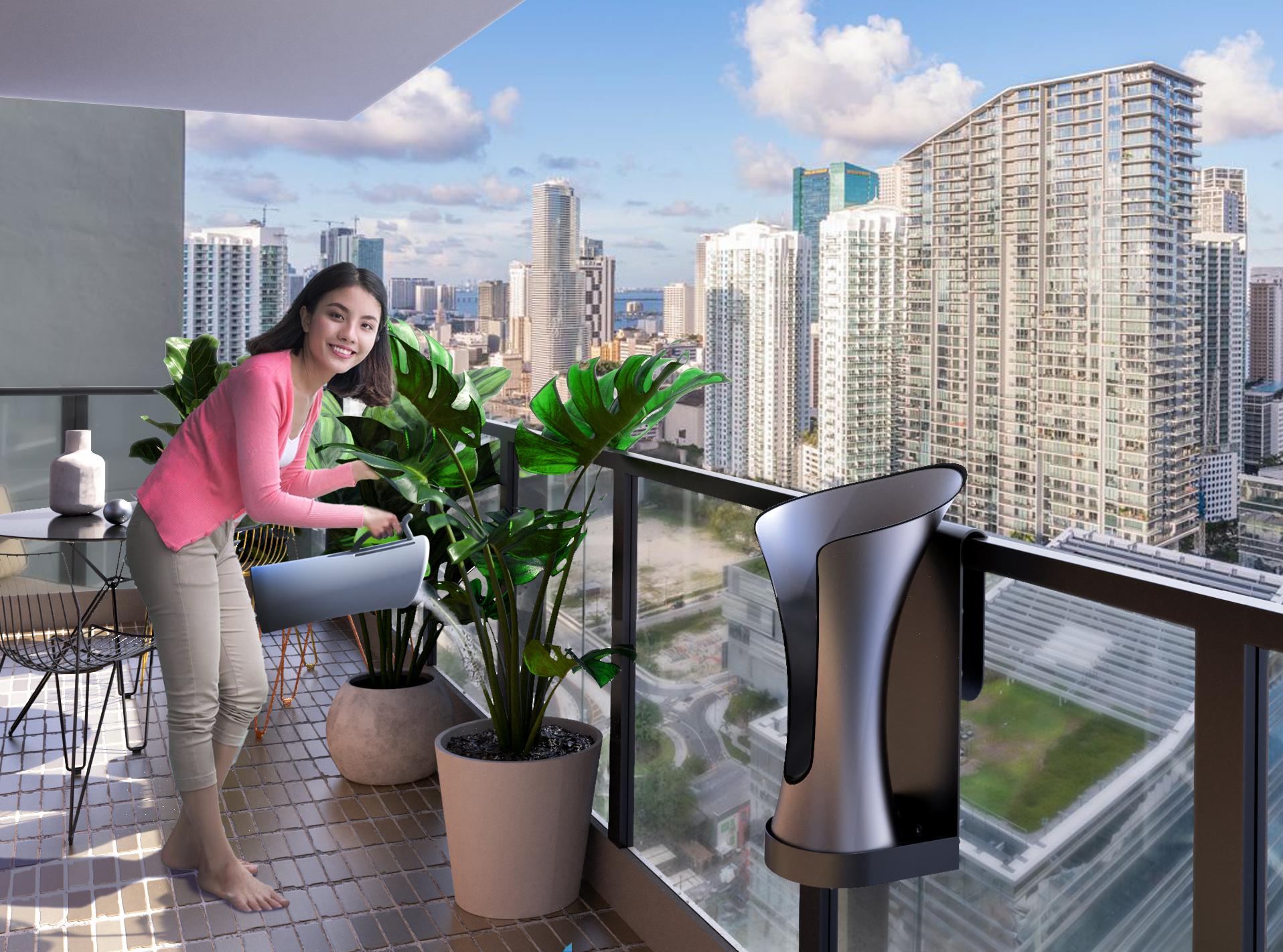 RainBloom Mini clamped to a sunny balcony railing while a person waters plants