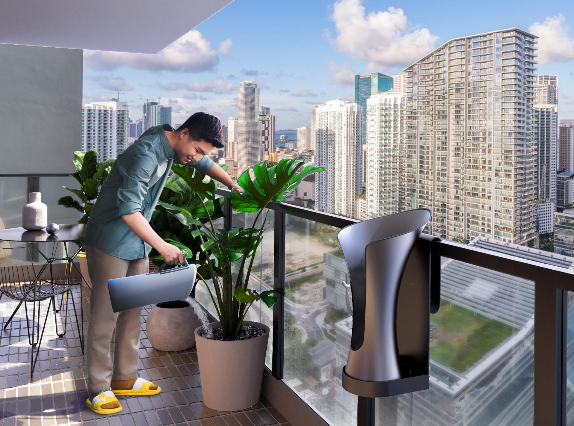 Person watering balcony plants with rainwater from the RainBloom Mini